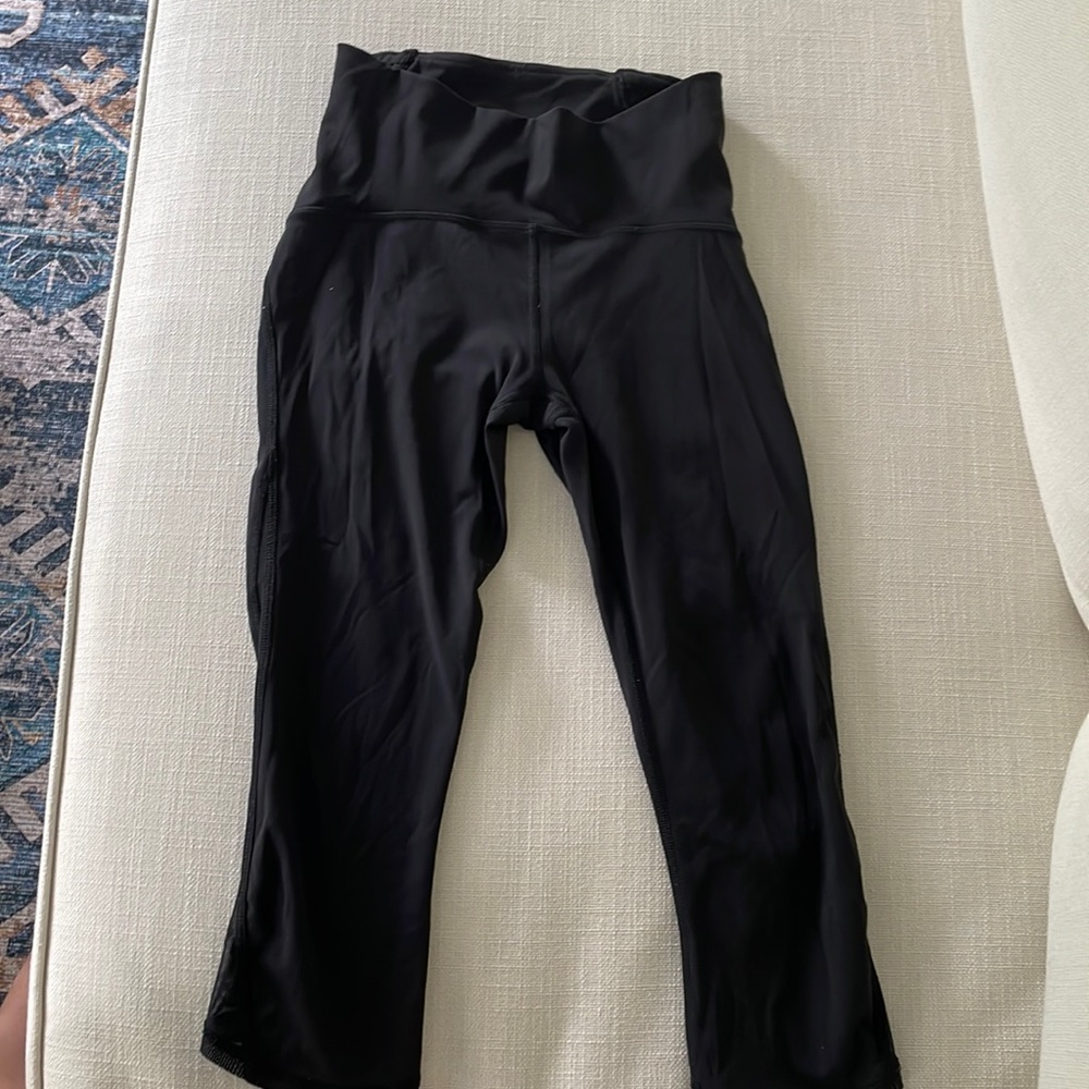 Lulu lemon black leggings. Size 4. Cropped at bottom with mesh sides.